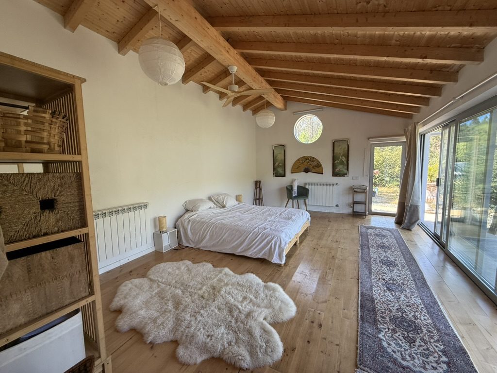 The bedroom studio, vaulted wooden ceiling, sheepskin on the floor